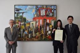 作品名「六月の野の土赫く」 感謝状を手にする柏木さん。 学長(右)、吉岡教授(左)とともに記念撮影 (於、学長応接室)